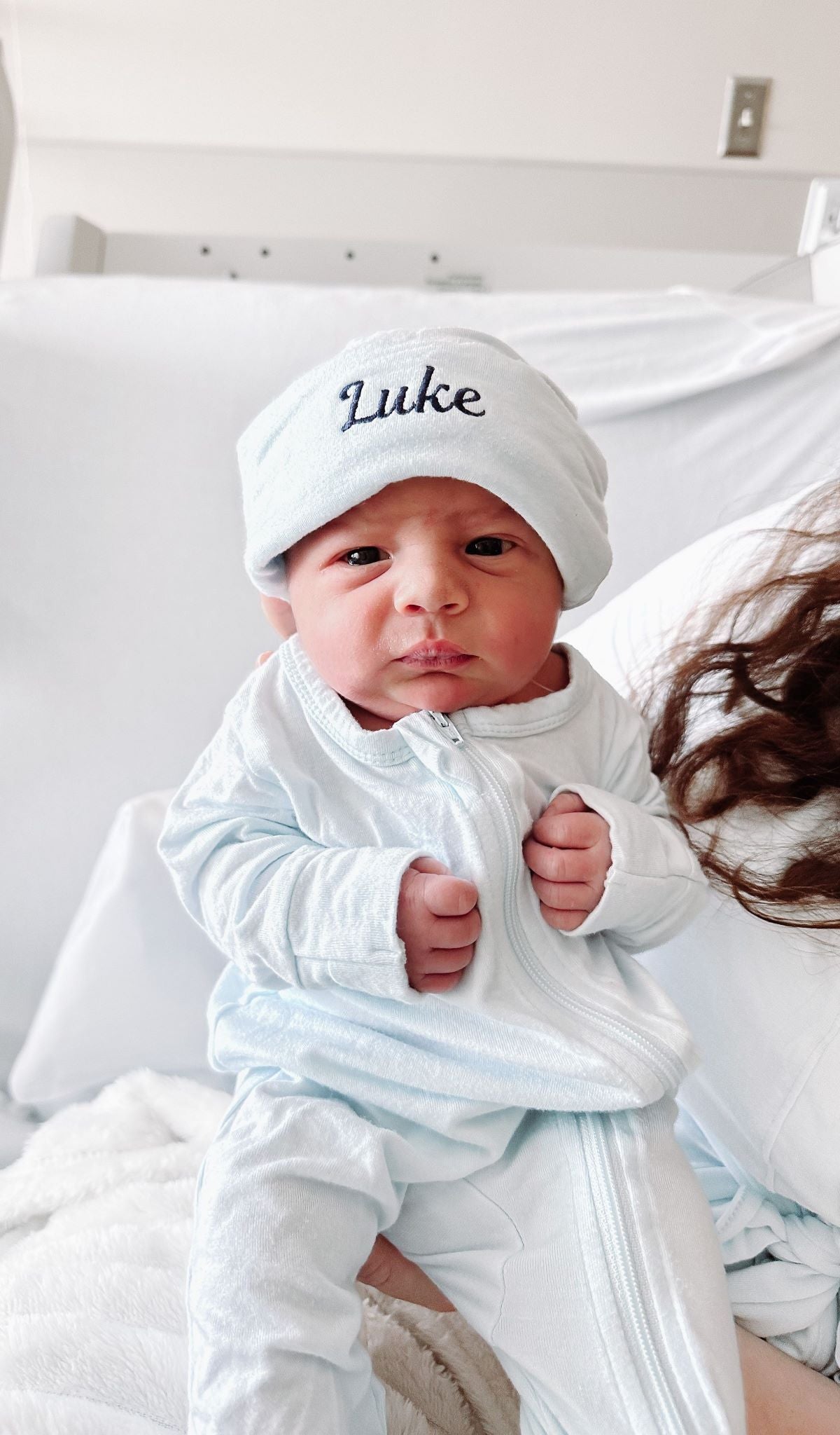 Whispering Blue Footie 2-Piece worn by baby. Hat has baby's name "Luke" embroidered on the cuff.