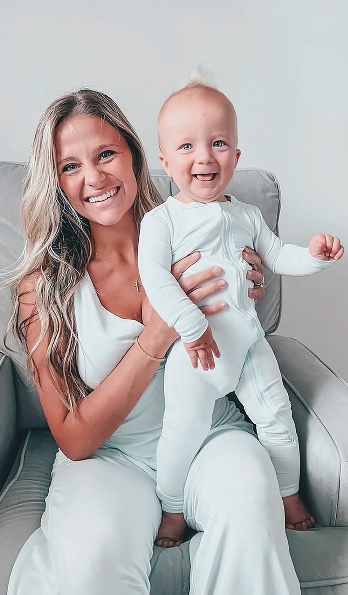 Whispering Blue Convertible Romper worn by baby boy, who is being held by his mom.