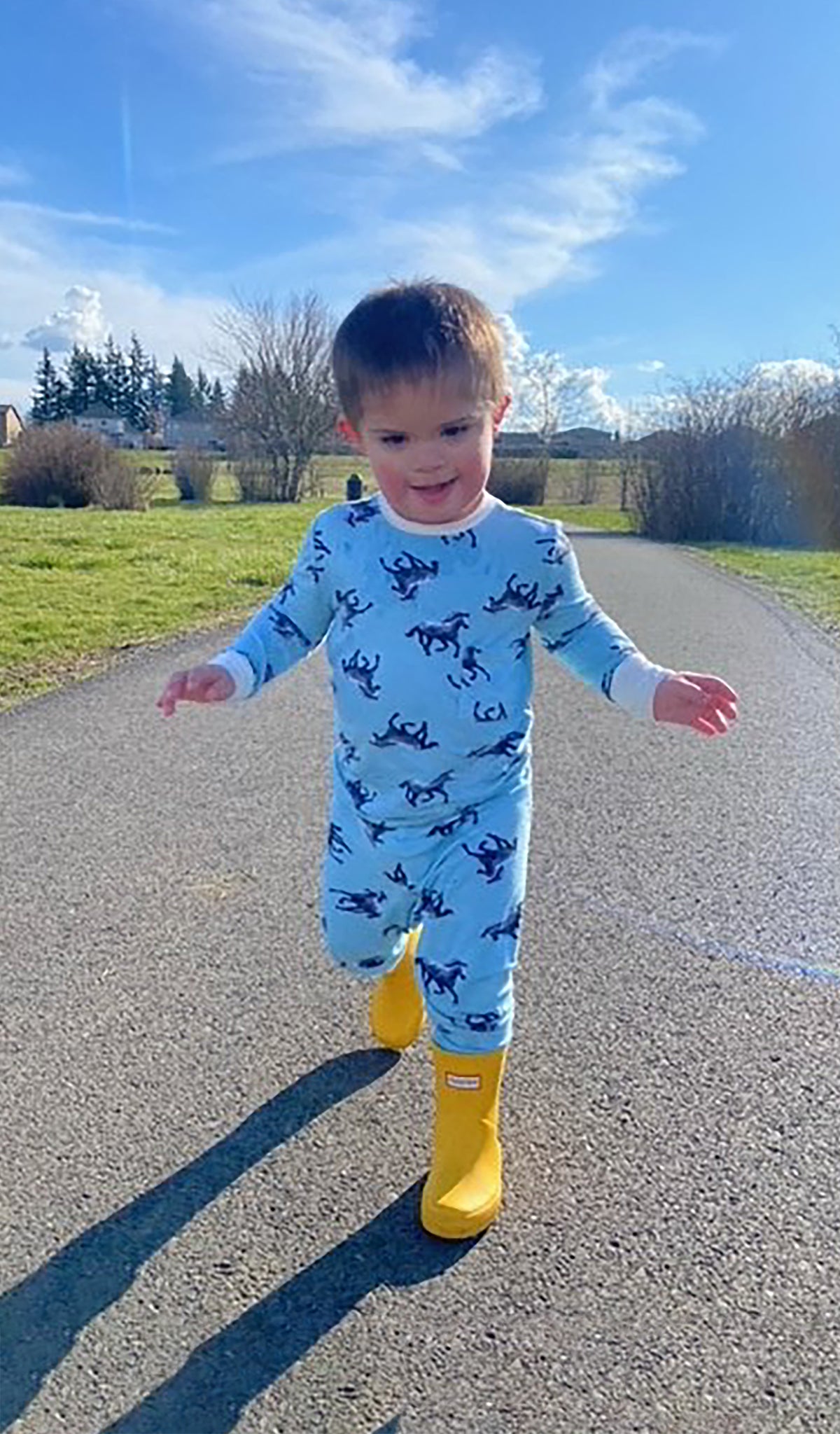 Horse Emerson Kids 2-Piece Pant PJ worn by little boy wearing yellow rainboots.