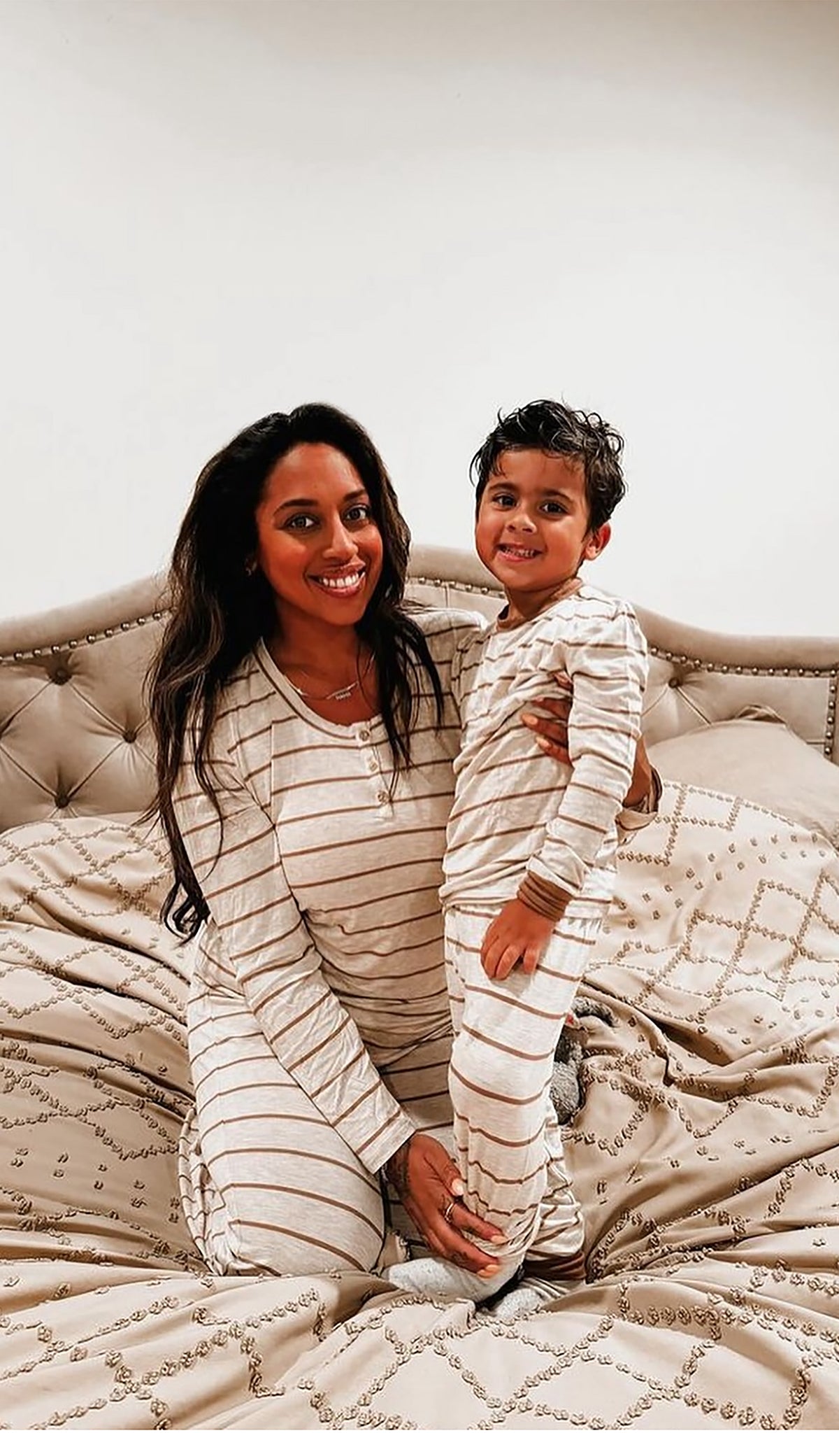 Mocha Stripe Emerson Kids 2-Piece Pant PJ worn by little boy standing next to his mom. Long sleeve top with cuff trim and long pant with cuff trim.