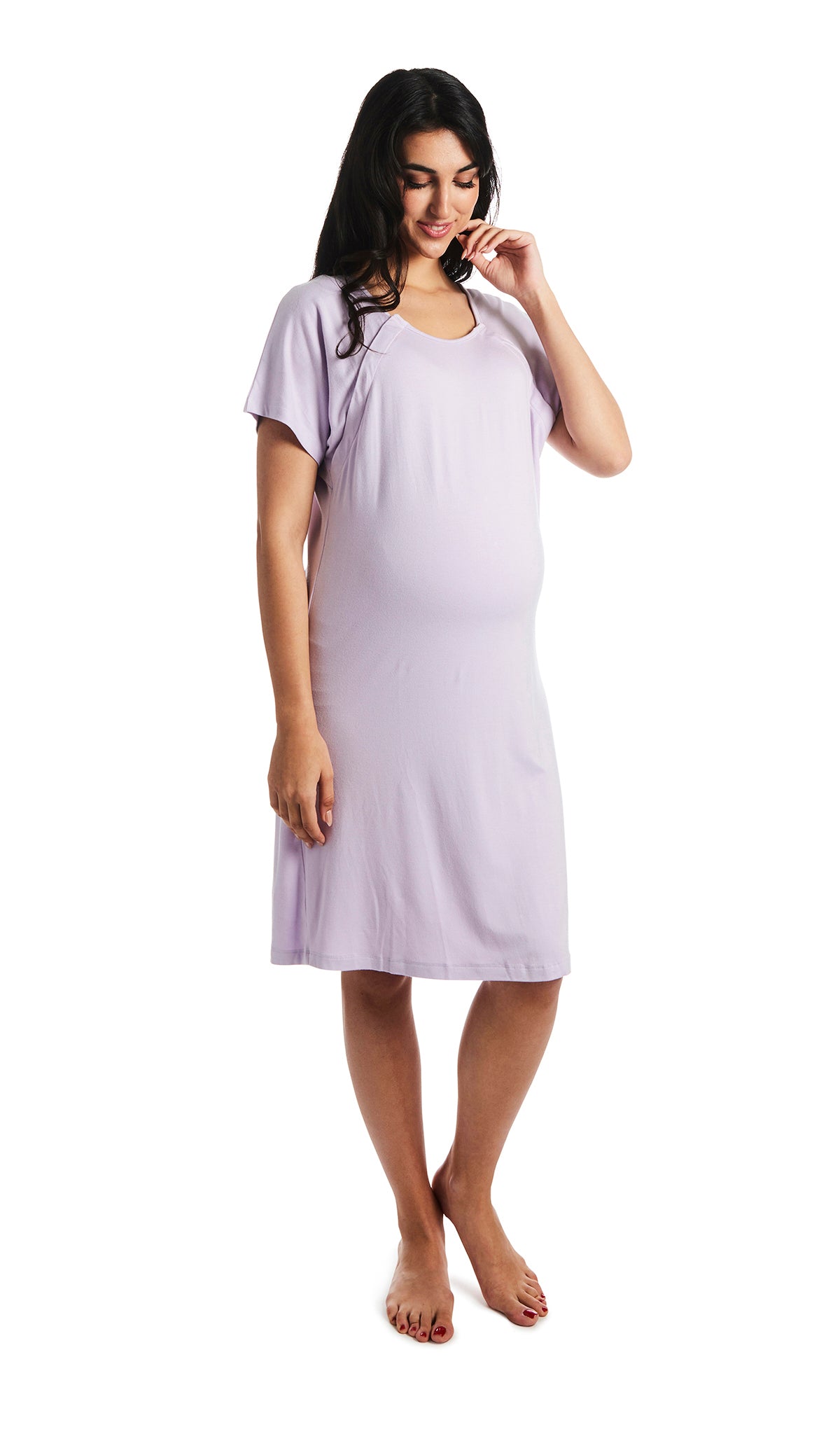 Lavender Rosa hospital gown. Pregnant woman wearing hospital gown with scoop-neckline featuring dual snap openings. One hand is down to side with fingers of other hand touching chin.