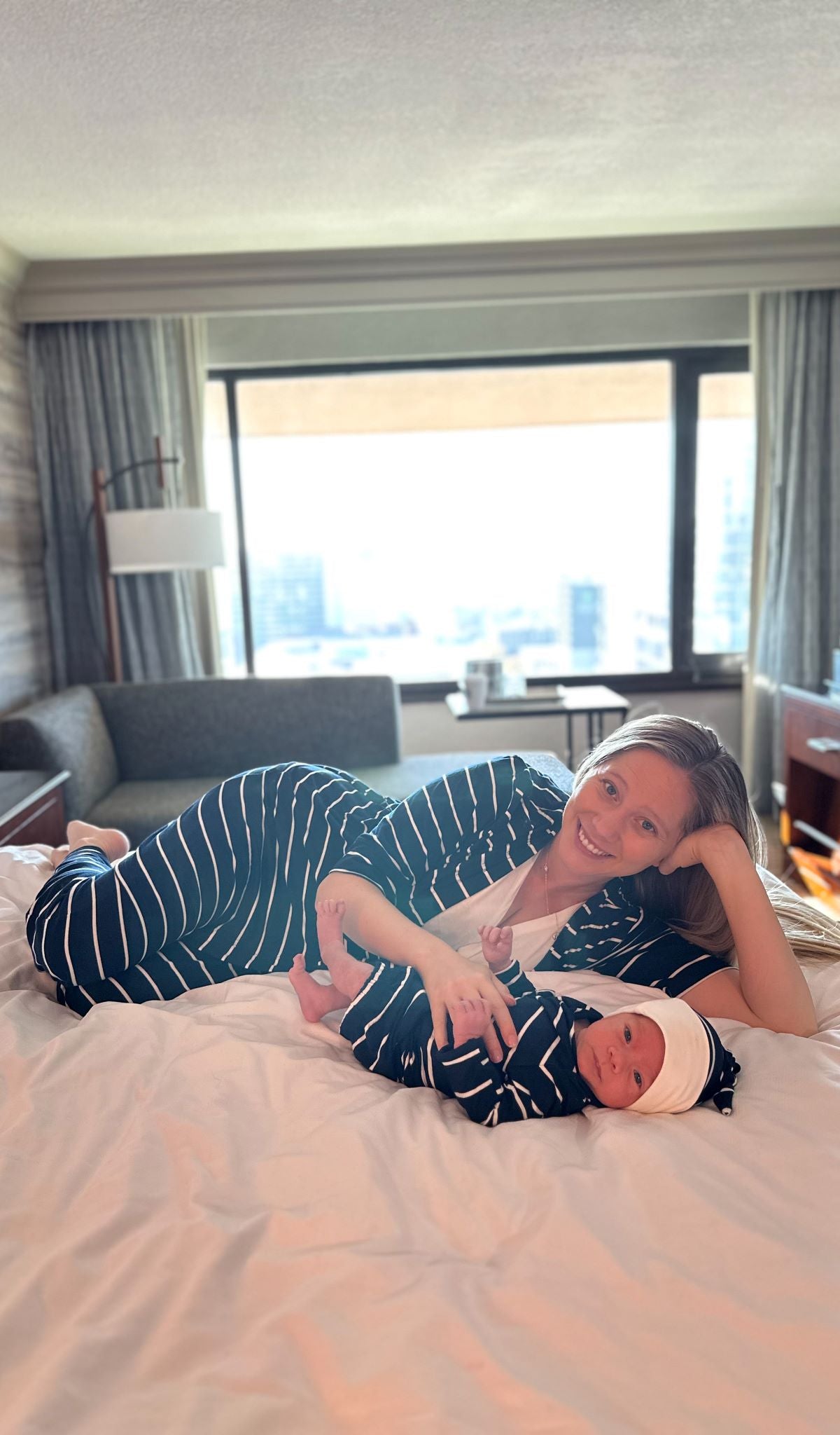 Navy Gown 2-Piece worn by baby laying on bed with his mom.