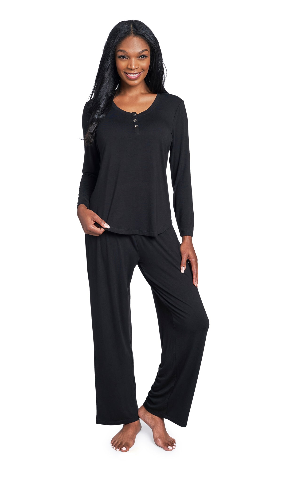 Black Laina 2-Piece Set. Woman wearing button front placket long sleeve top and pant with one hand holding hem of shirt.