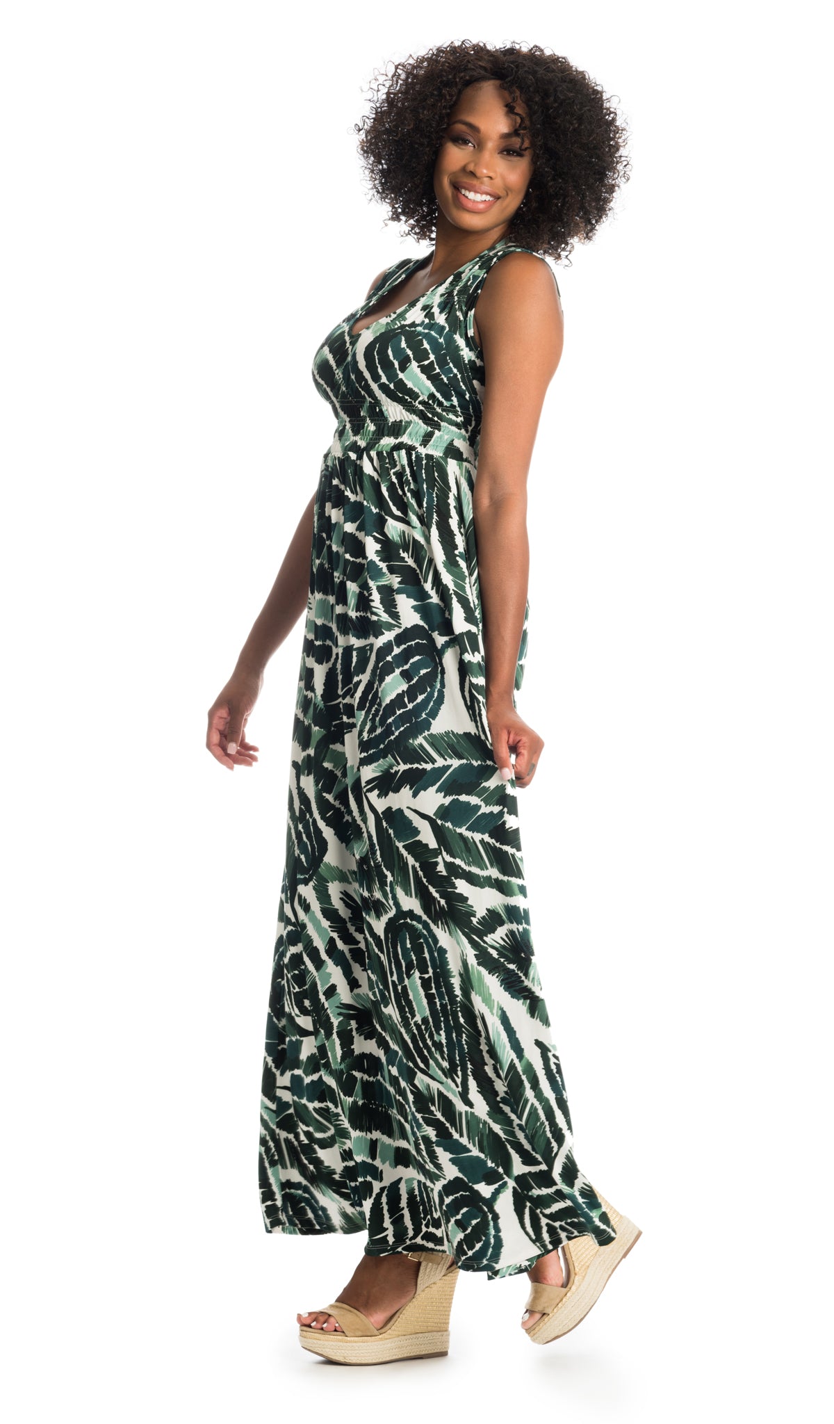 Palm Valeria dress worn as non-maternity style by woman holding side of dress with one hand.