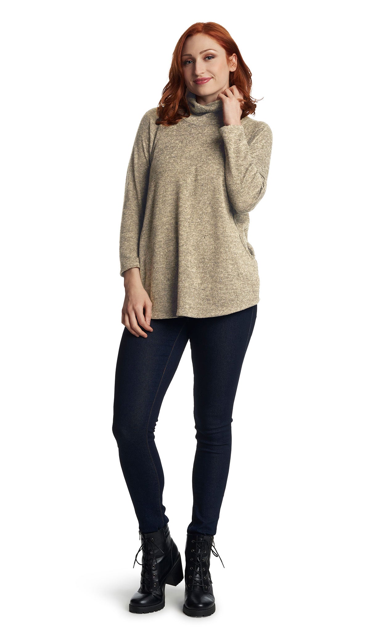 Mocha Teresa Sweater. Full length shot of pregnant woman wearing Teresa Sweater and dark denim jeans and booties with one hand touching collar.